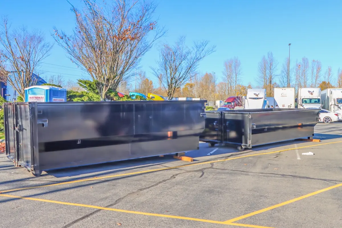 Professional dumpster rental service with roll-off container on residential driveway in East Lampeter